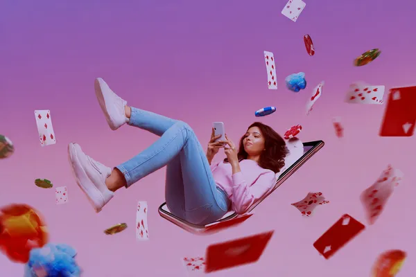 A young woman relaxing with her phone while dynamic casino elements float around her, illustrating the smooth mobile experience offered by the D71 app.